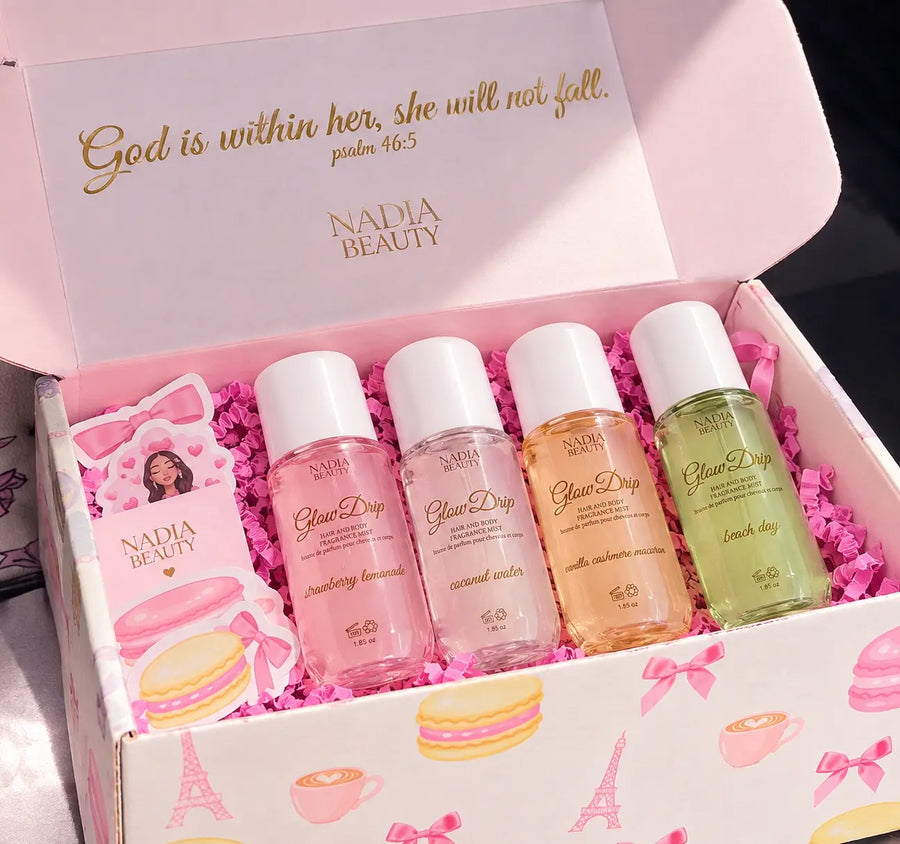 Nadia Beauty Clear Drop facial toner set in a pink gift box with macaron and Eiffel Tower illustrations. The open box contains four small clear bottles filled with pink, clear, peach, and green liquids, surrounded by pink paper filler, with a matching pink card and inner lid featuring gold scripture text.