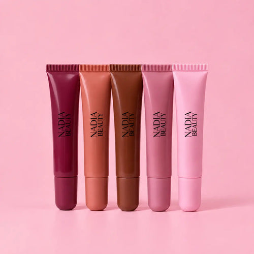 Five Nadia Beauty Macaron Lip Butter Tints on a pink background