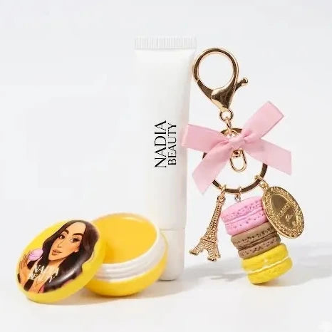 Keychain with macaron designs and a bottle labeled 'Nadia Beauty' on a white background