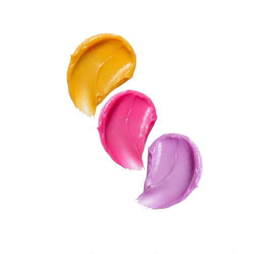 Three colorful lip balm swatches on a white background