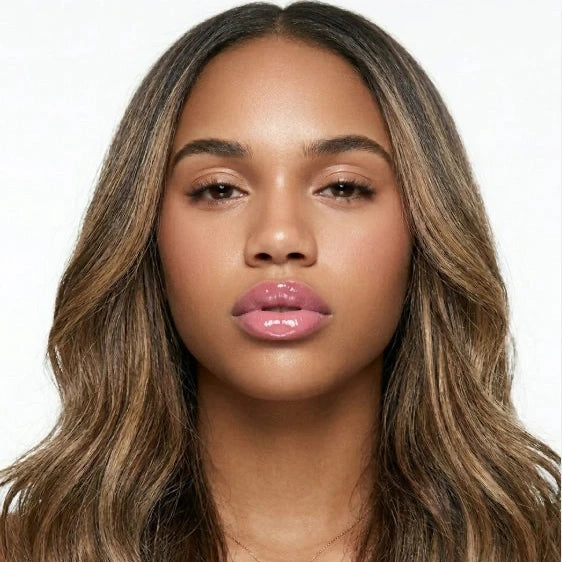 Woman wearing strawberry lip balm on a white background